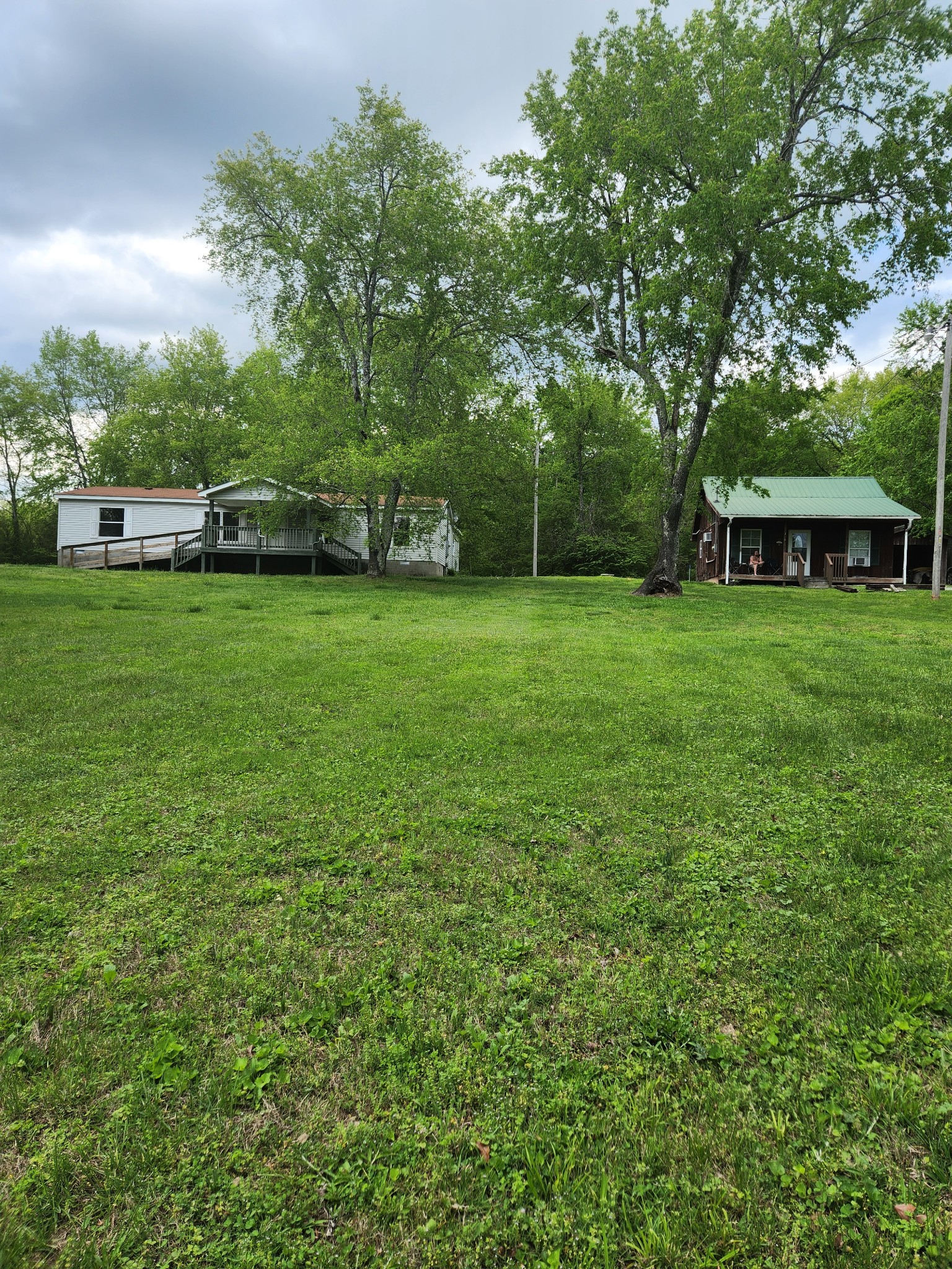 1261 Garton Road Burns, TN 37029 - Photo 1 of 11 a front view of a house with a garden