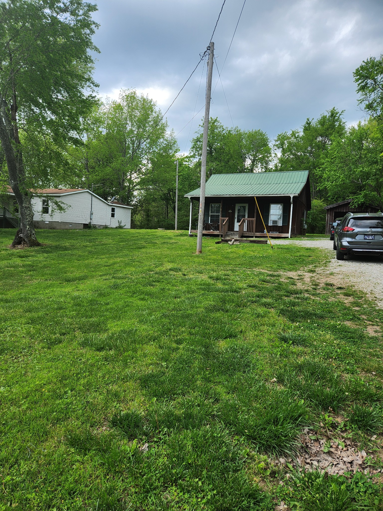 1261 Garton Road Burns, TN 37029 - Photo 6 of 11 a front view of a house with a garden