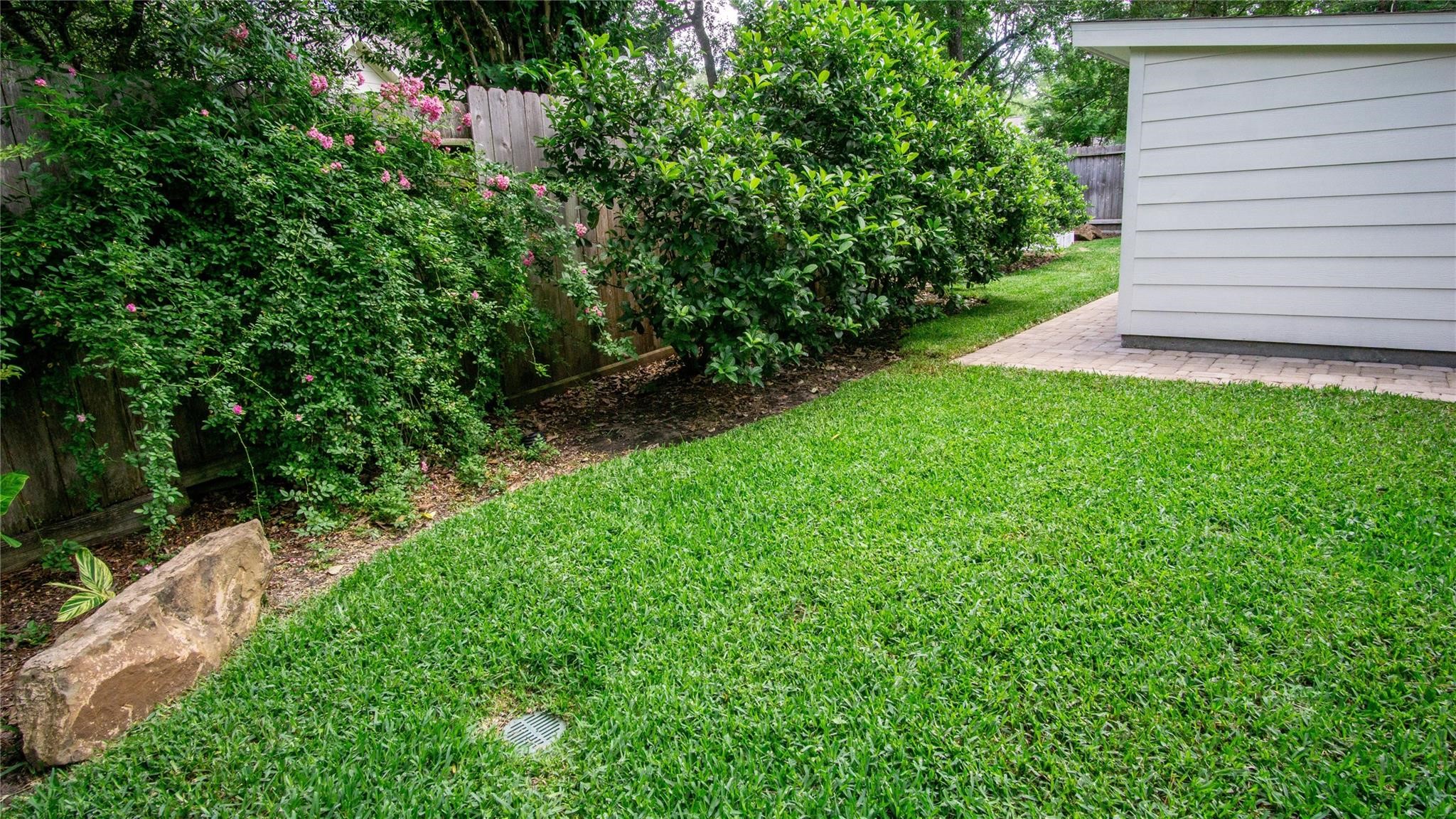 10 Belcarra Place Spring, TX 77382 - Photo 41 of 49 Beautiful landscaping & hardscaping/paverstone surround the home. Huge storage shed placed discreetly in the back of the patio room provides so much storage you can actually use your garage!
