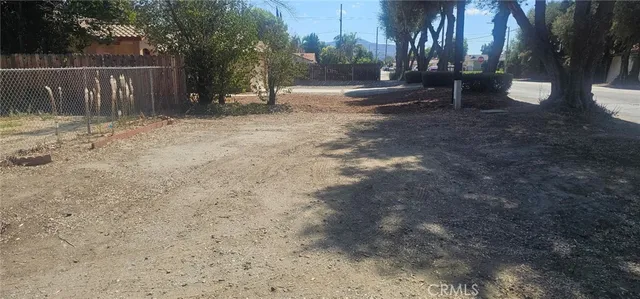 a view of patio with couches and chairs under an umbrella