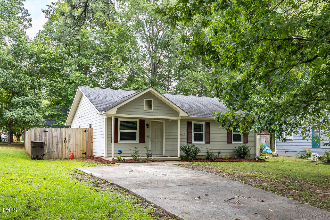 a front view of a house with a garden and yard