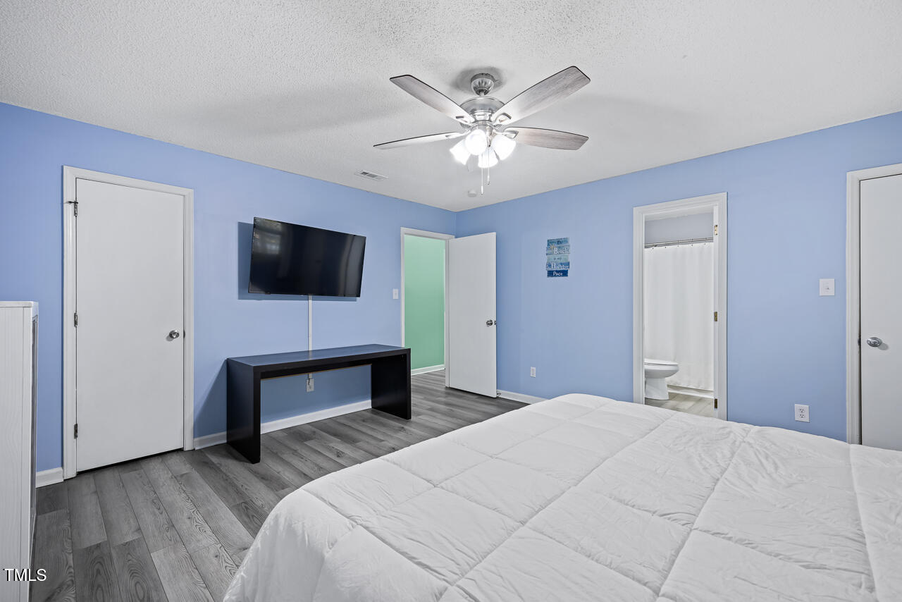 2906 Apollo Street Durham, NC 27704 - Photo 15 of 23 a bedroom with a bed and a flat screen tv
