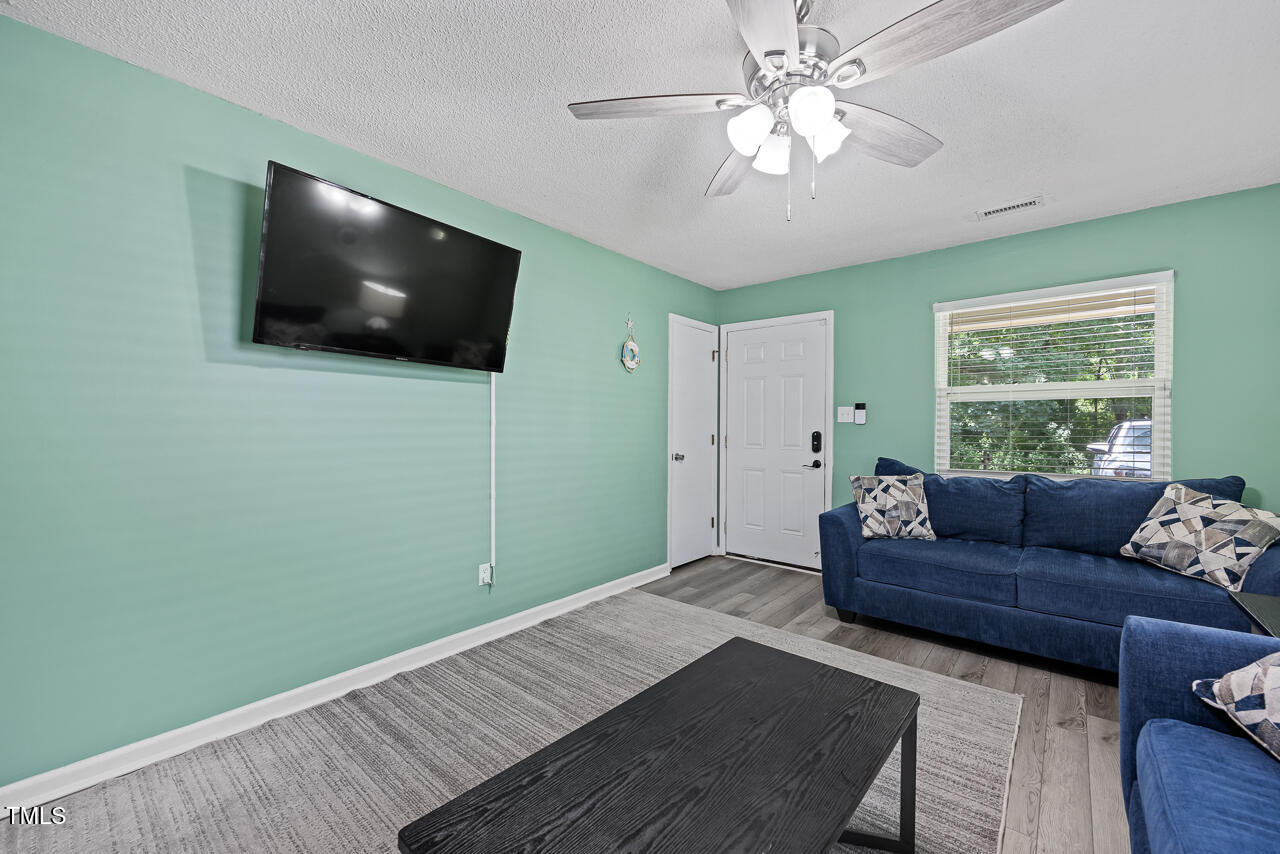 2906 Apollo Street Durham, NC 27704 - Photo 6 of 23 a living room with furniture and a flat screen tv