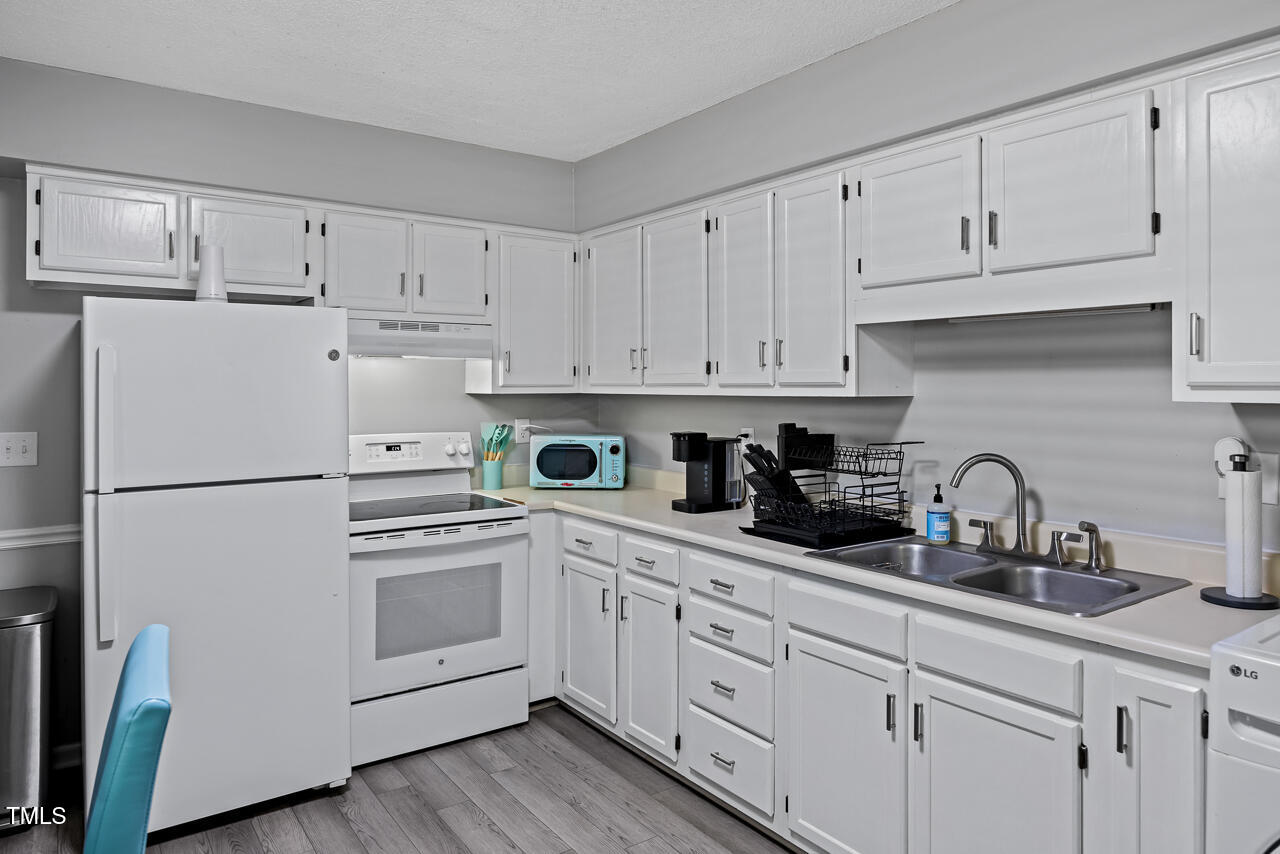 2906 Apollo Street Durham, NC 27704 - Photo 8 of 23 a kitchen with white cabinets and white appliances