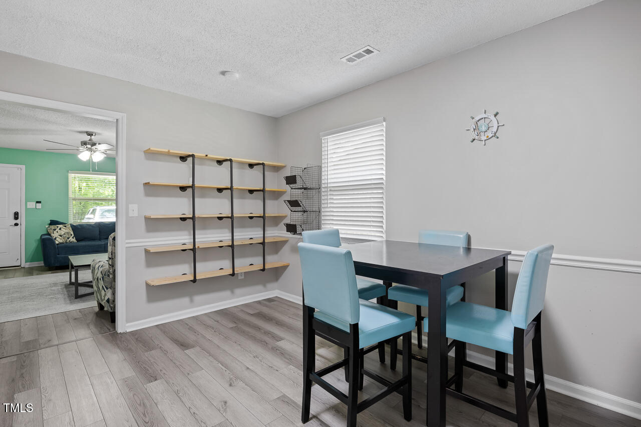2906 Apollo Street Durham, NC 27704 - Photo 10 of 23 a view of a dining room with furniture and wooden floor