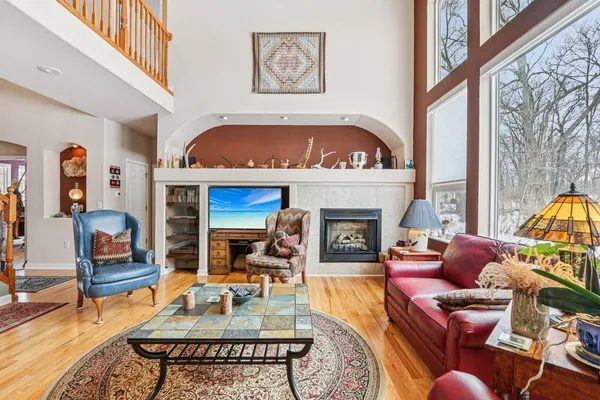 a living room with furniture a rug and a fireplace