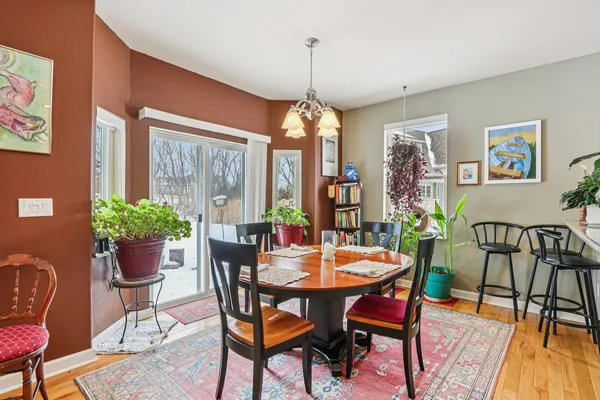 a dining room with furniture window and wooden floor