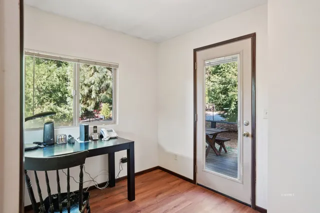 a view of room with window and wooden floor