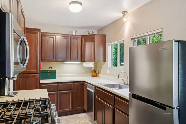 a kitchen with a refrigerator and a sink