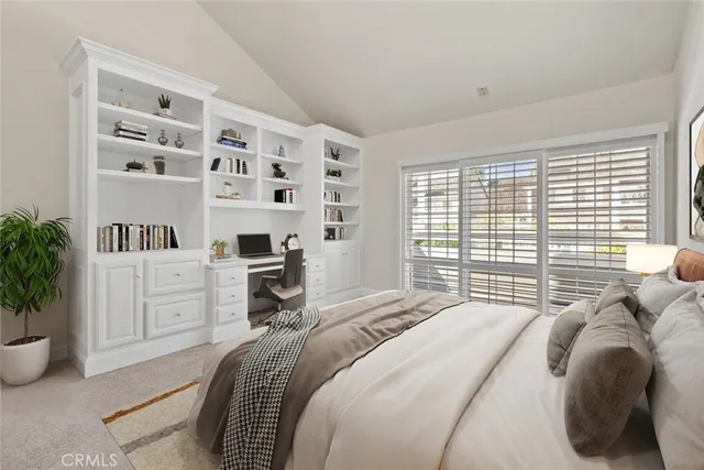a bedroom with a bed and a large window