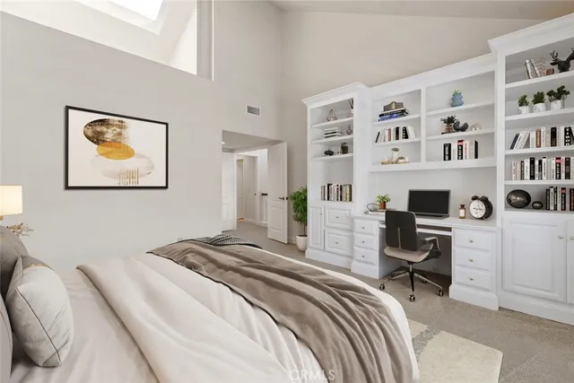 a bedroom that has a bed and a workspace