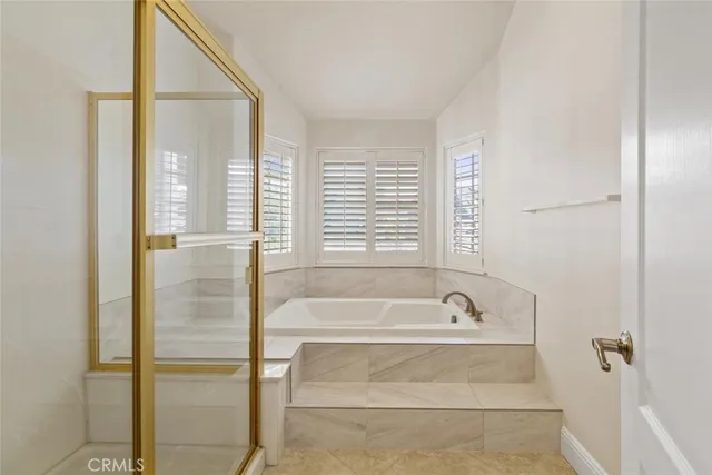 a spacious bathroom with sink shower and bathtub
