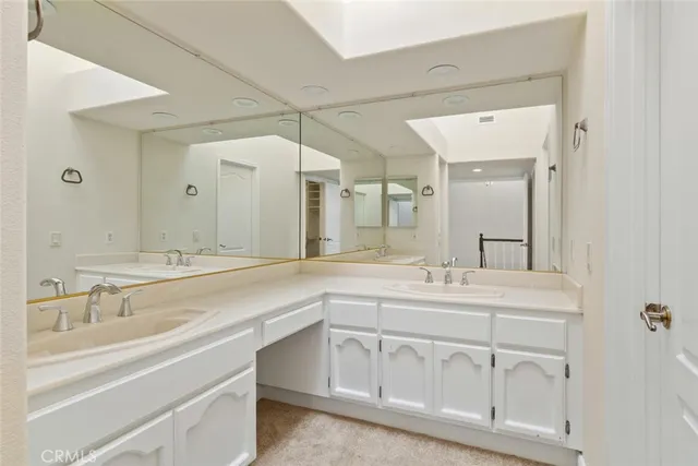 a bathroom with a sink vanity and mirror