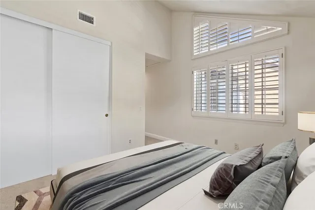 a bedroom with a bed and a window