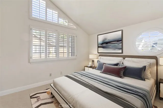 a bedroom with a bed and a large window