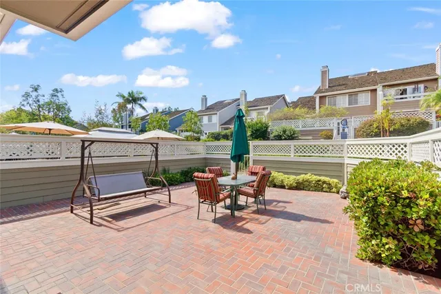 a view of a patio with a table and chairs