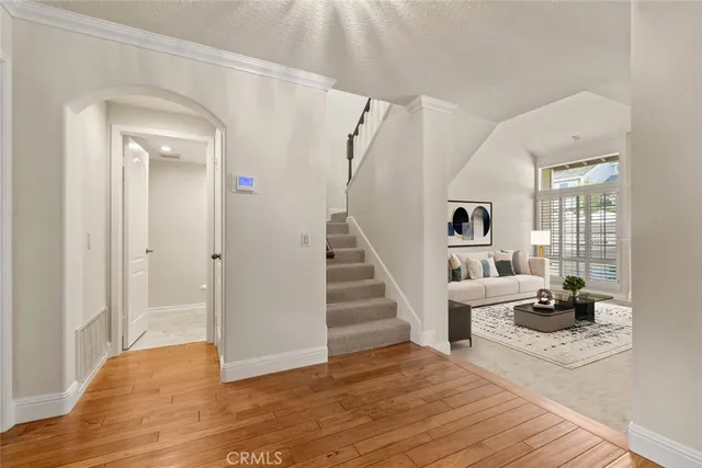 a view of a livingroom with wooden floor and furniture