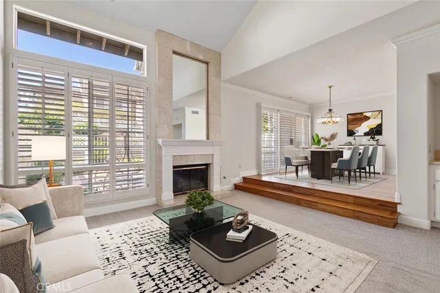 a living room with furniture a fireplace and a table