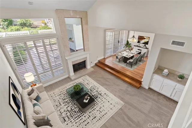 a living room with furniture and a fireplace