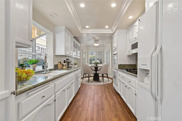 a large kitchen with stainless steel appliances lots of counter space and wooden floor