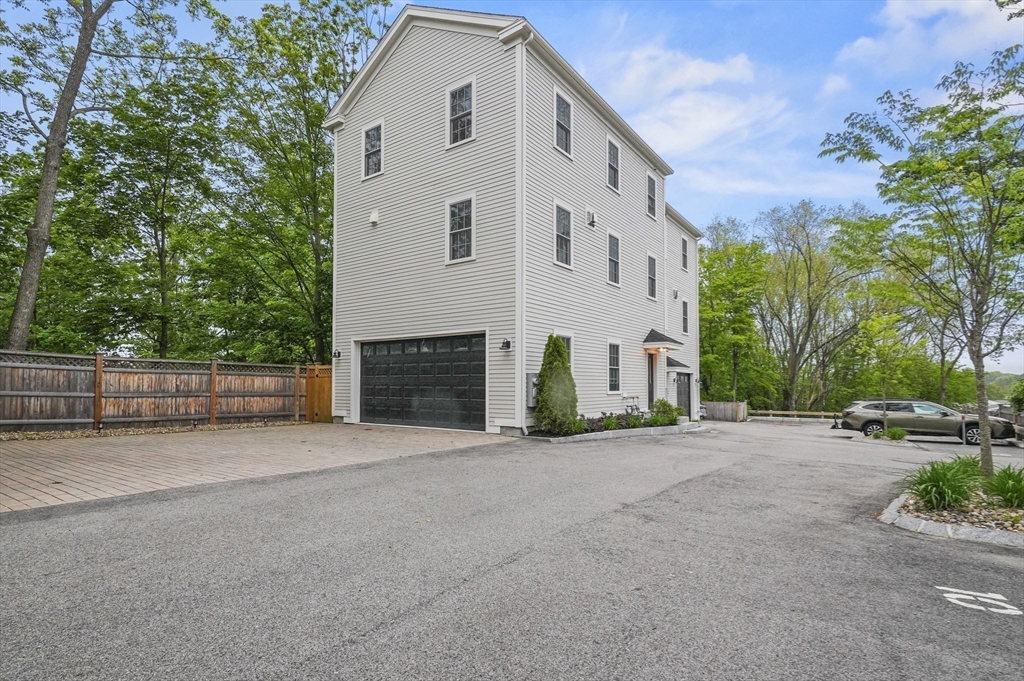 140 Main Street, Unit E Amesbury, MA 01913 - Photo 28 of 35 a view of a house with a yard and tree s