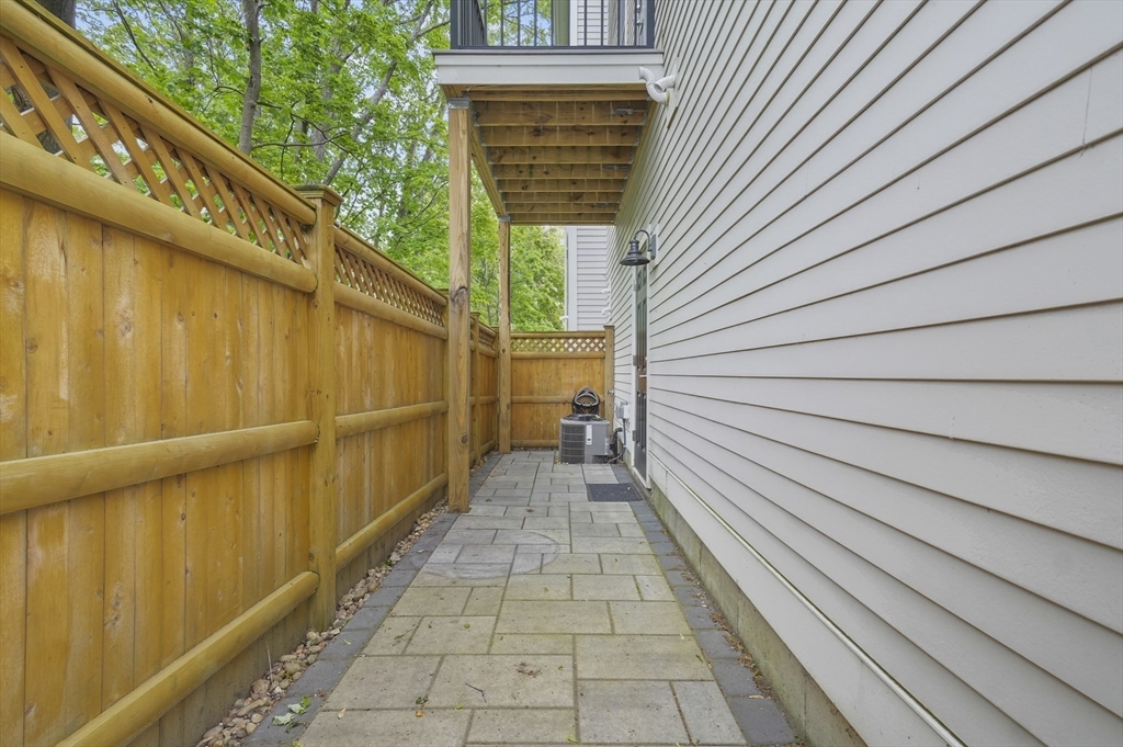 140 Main Street, Unit E Amesbury, MA 01913 - Photo 31 of 35 a view of a balcony with wooden floor and stairs
