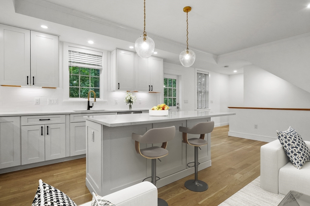 140 Main Street, Unit E Amesbury, MA 01913 - Photo 6 of 35 a kitchen with a table chairs sink and cabinets