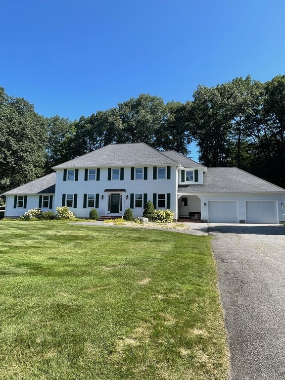 a view of a house with pool and a yard