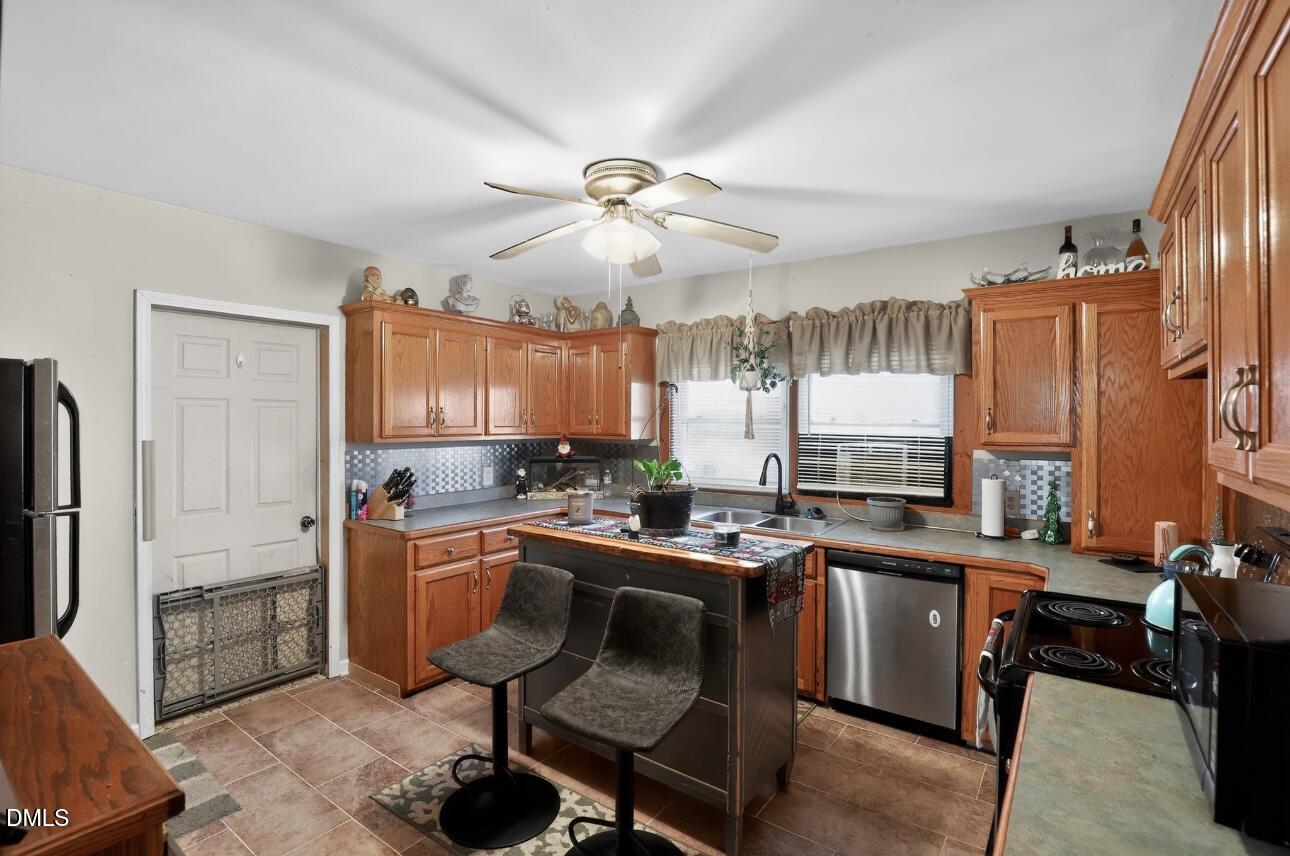 860 Virginia Road Marion, NC 28752 - Photo 12 of 23 a kitchen with a table chairs refrigerator and sink