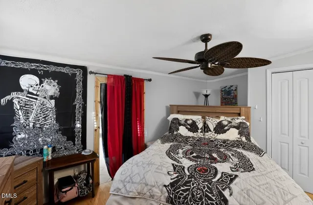 a bedroom with a bed and a chandelier