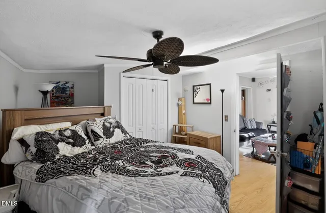 a bedroom with a bed and glass walk in closet