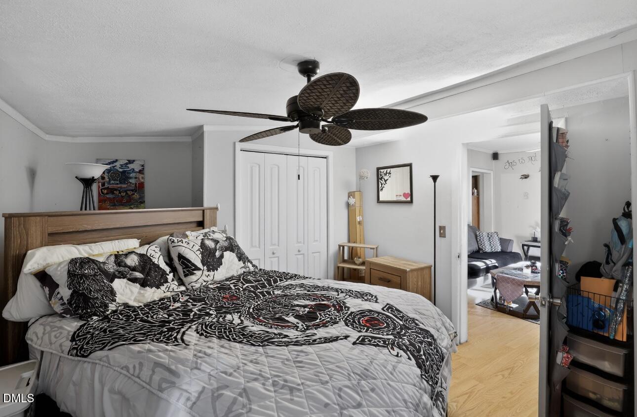 860 Virginia Road Marion, NC 28752 - Photo 16 of 23 a bedroom with a bed and glass walk in closet