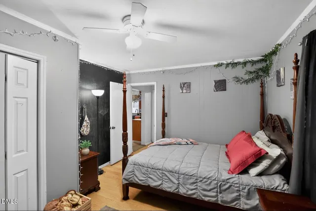 a bedroom with a bed and a chandelier