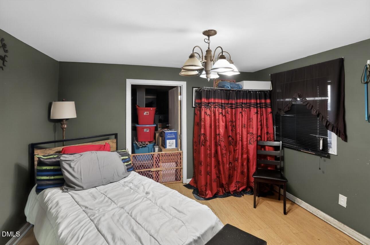 860 Virginia Road Marion, NC 28752 - Photo 19 of 23 a bedroom with a bed and a chandelier