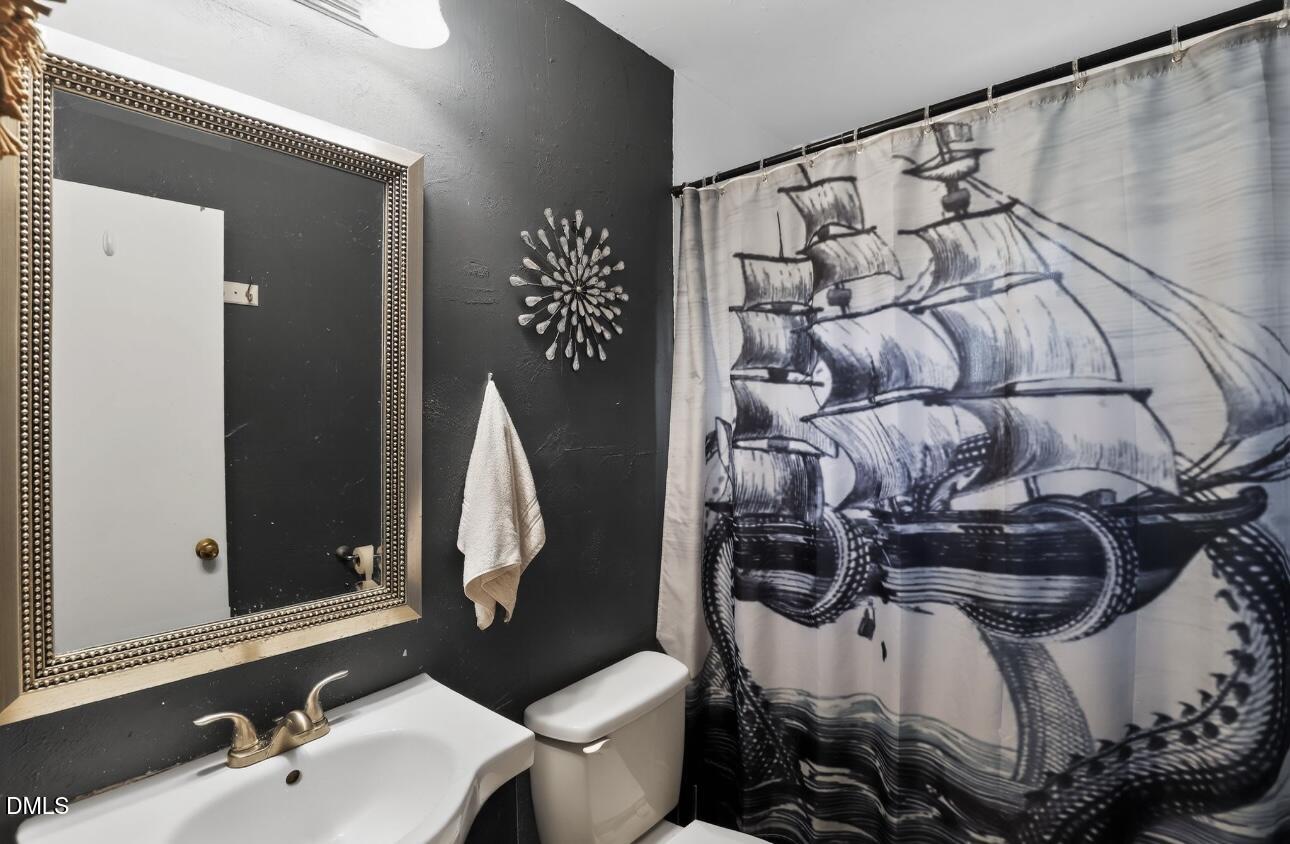 860 Virginia Road Marion, NC 28752 - Photo 23 of 23 a bathroom with a sink and mirror with toilet