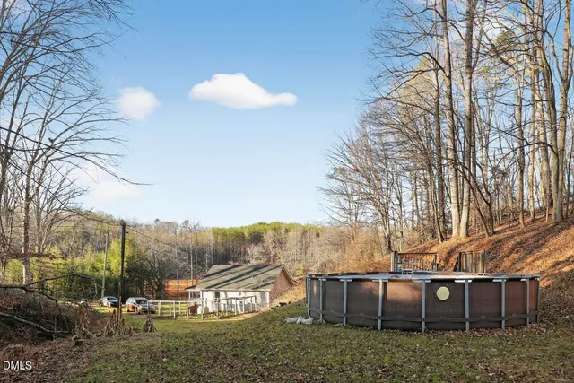 a view of a big yard with table and chairs