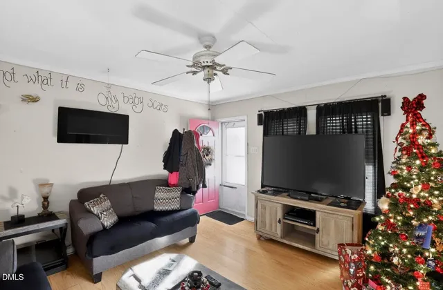 a living room with furniture and a flat screen tv