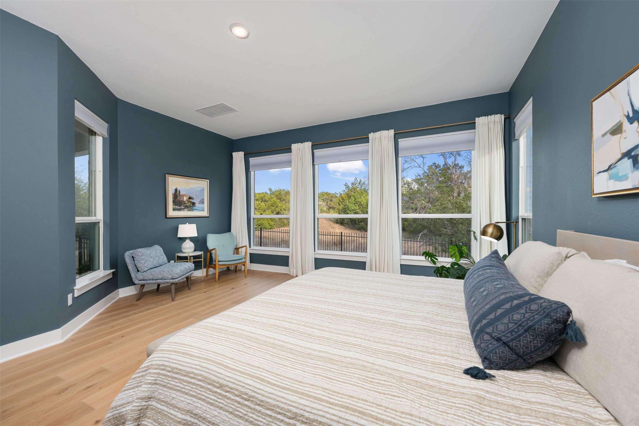438 Pear Tree Lane Austin, TX 78737 - Photo 13 of 40 a spacious bedroom with a bed and large windows