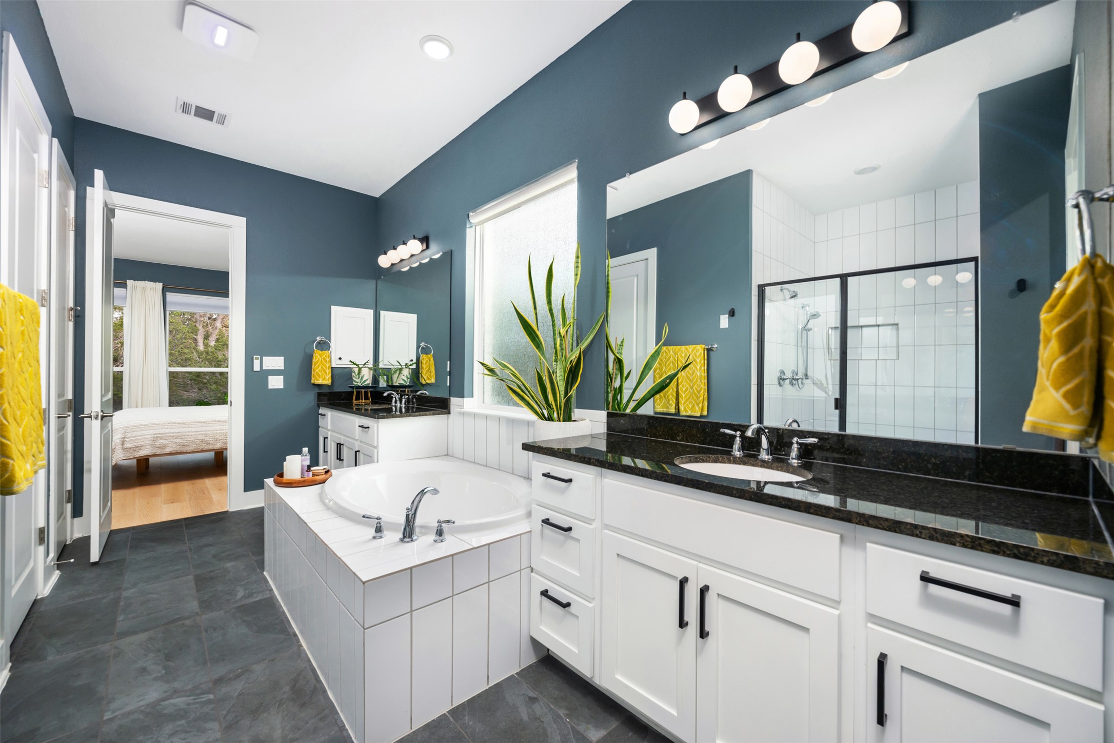 438 Pear Tree Lane Austin, TX 78737 - Photo 15 of 40 a bathroom with a double vanity sink and a mirror