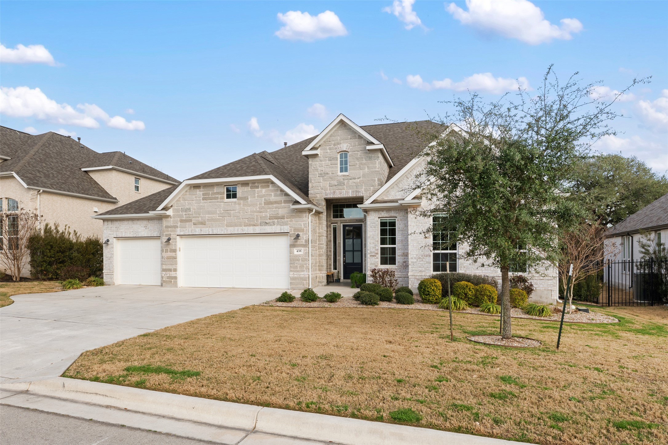 438 Pear Tree Lane Austin, TX 78737 - Photo 2 of 40 a front view of a house with a yard and garage