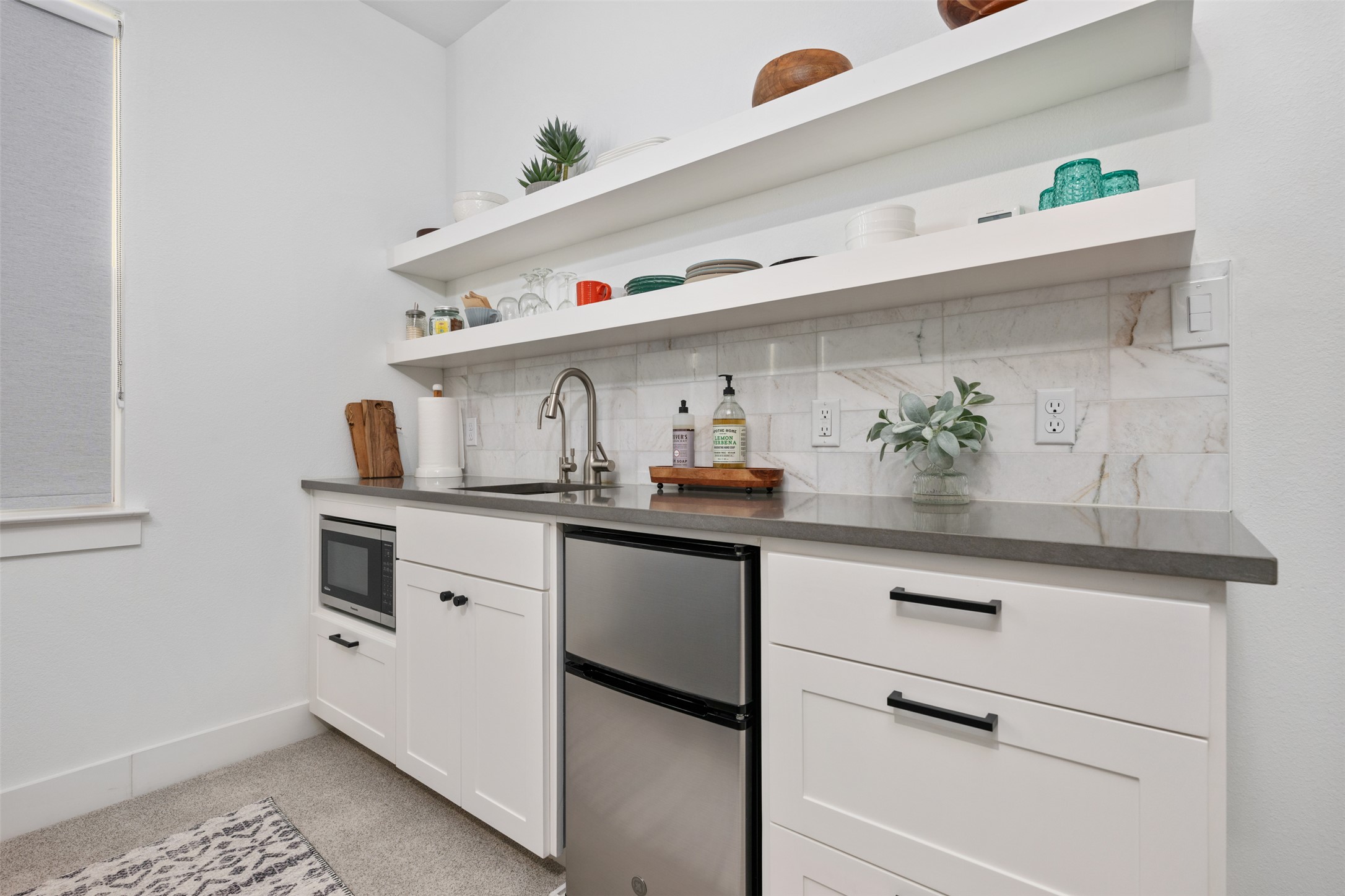 438 Pear Tree Lane Austin, TX 78737 - Photo 29 of 40 a kitchen with white cabinets and appliances