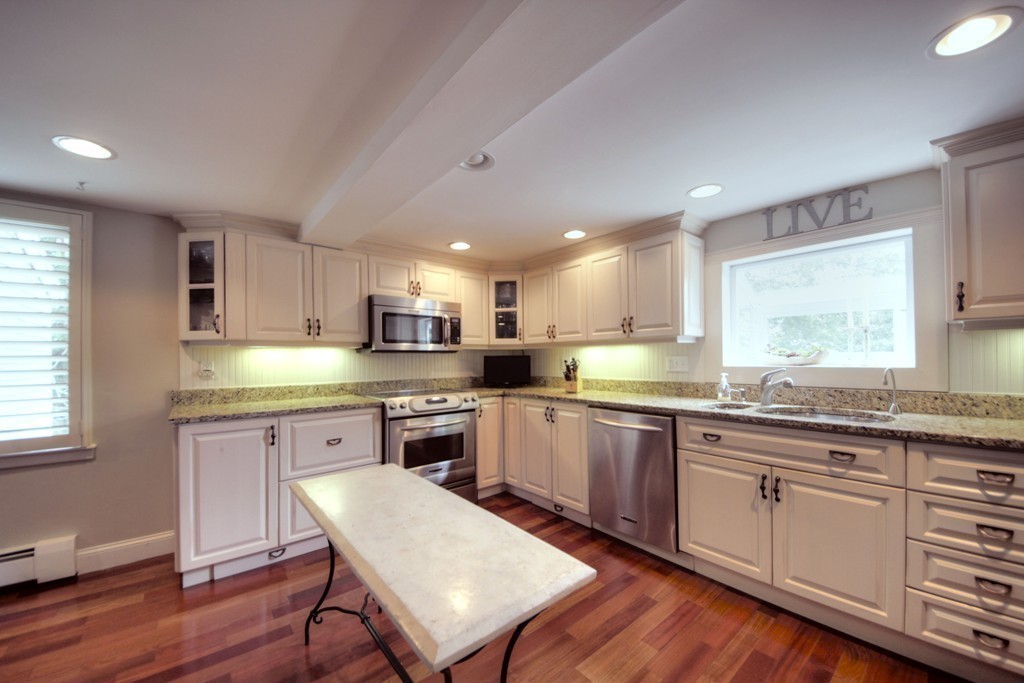 158 Evans Rd Extension Marblehead, MA 01945 - Photo 16 of 30 a kitchen with stainless steel appliances granite countertop wooden floor sink stove and table