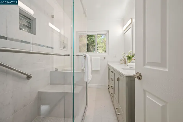 a bedroom with a bed and a large window