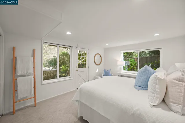 a bedroom with a bed and a large window