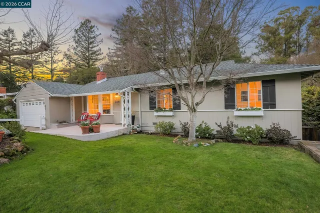 a front view of house with yard and outdoor seating