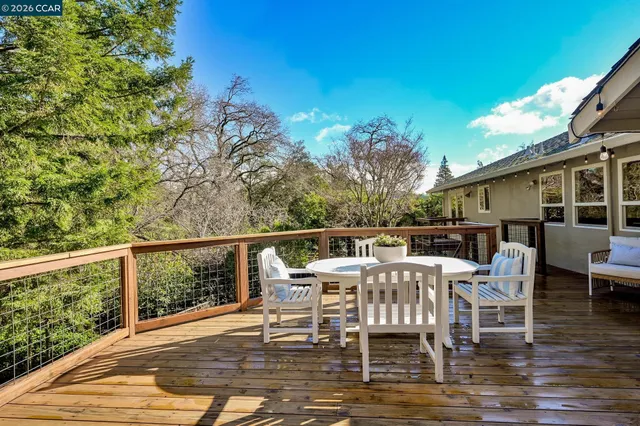 a balcony with wooden floor and furniture
