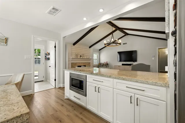 a kitchen with granite countertop a sink and stainless steel appliances