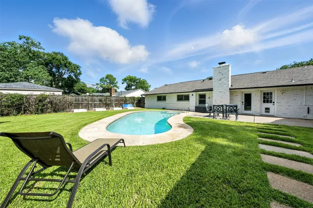 a view of a house with a yard table and chairs