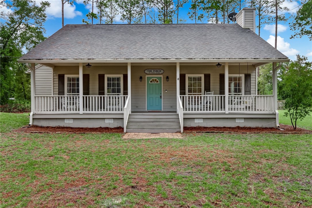96242 Lang Road Yulee, FL 32097 - Photo 1 of 32 a front view of a house with a garden