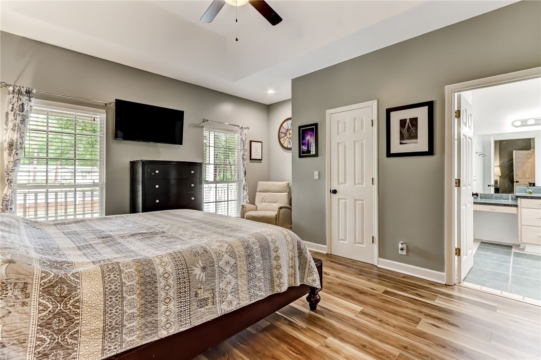 96242 Lang Road Yulee, FL 32097 - Photo 17 of 32 a bedroom with a large bed and a flat screen tv